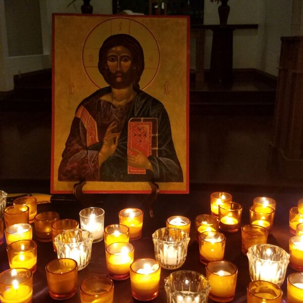 Icon frame and candles lit for Taize